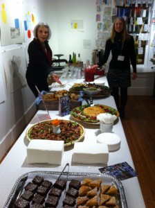 Board members Flo Larson and Polly Prindle-Hess put the finishing touches on the refreshments provided by Maura's Cafe.